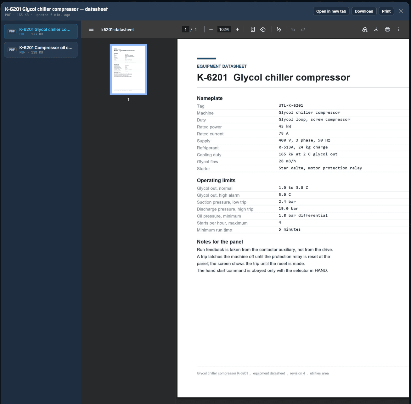 the datasheet opened from the machine's own door, with the other documents beside it
